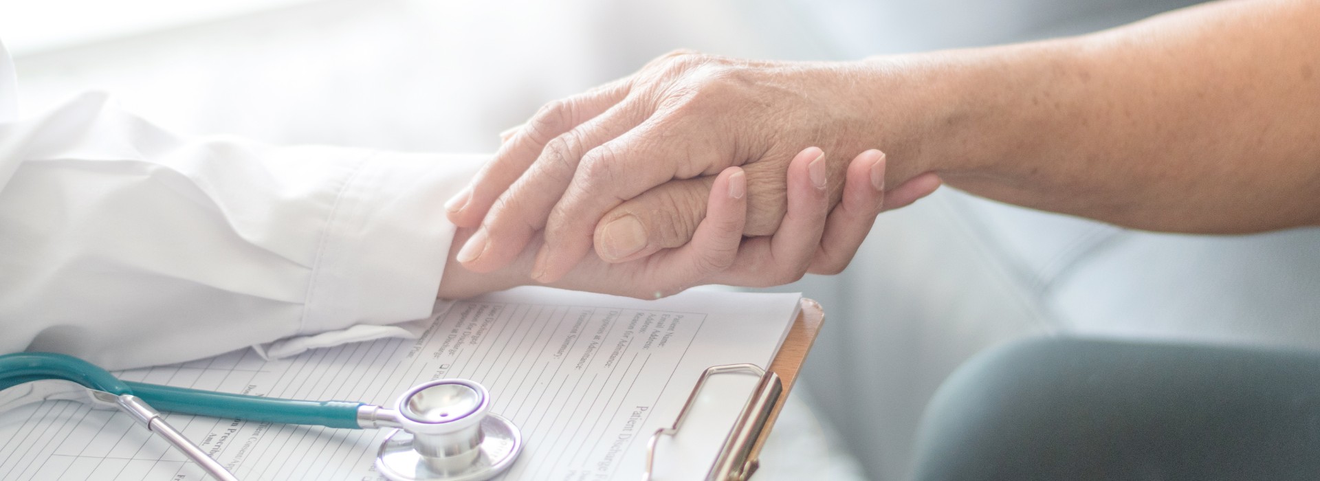 Doctor and patient holding hands Gracia Hospice home health care